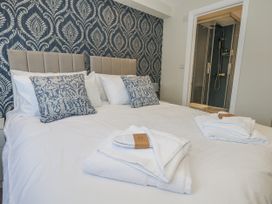 A bedroom with a bed and a shower area at Vista Mare 1 Weymouth