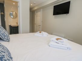 A bedroom with a bed and television at Vista Mare 1 Weymouth