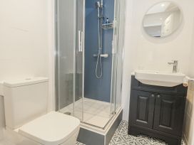 A bathroom with a shower and vanity at Vista Mare 1 Weymouth