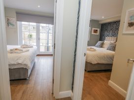 Two bedrooms with beds and towels at Vista Mare 1 Weymouth