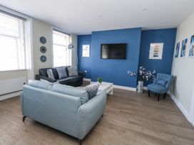 A living room with a television and seating area at Apartment 2 in Weymouth
