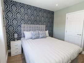 A bedroom with a bed and bedside table at Apartment 2 in Weymouth