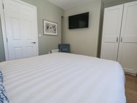 A bedroom with a bed and wardrobe at Apartment 2 in Weymouth