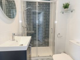 A bathroom featuring a shower, sink, and toilet at Apartment 2 in Weymouth
