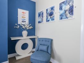 A hallway with a console table and chair at Vista Mare 2 Weymouth