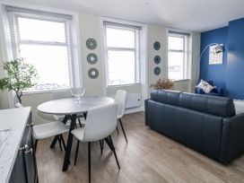 A living room with a dining table and sofa at Vista Mare 2 in Weymouth