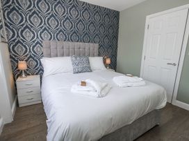 A bedroom with a bed and nightstand at Vista Mare 2 Weymouth