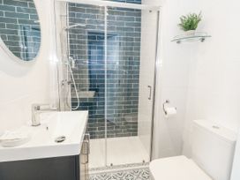 A bathroom with a shower, sink, and toilet at Vista Mare 2 in Weymouth