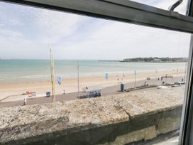 A view of the sea and beach from a window at Apartment 3 in Weymouth
