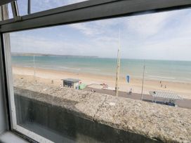 A view of the beach and sea from a window at Apartment 3 in Weymouth