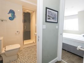 A bathroom with shower and toilet at Apartment 3 in Weymouth
