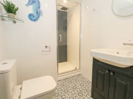 A bathroom with a sink, shower, and toilet at Apartment 3 in Weymouth
