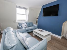 A living room with a sofa and television at Vista Mare 3 in Weymouth