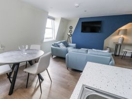 A living room with a table and chairs at Vista Mare 3 Weymouth