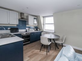 A kitchen with a table and chairs at Vista Mare 3 Weymouth