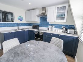 A kitchen with cabinets and appliances at Vista Mare 3 Weymouth