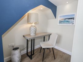 An office corner with a table and lamp at Vista Mare 3 Weymouth