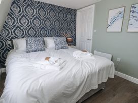 A bedroom with a bed and wall art at Vista Mare 3 Weymouth
