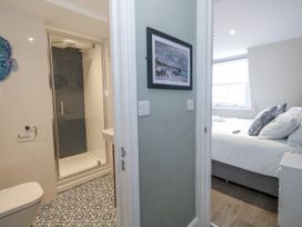 A bathroom with a shower and toilet at Vista Mare 3 Weymouth