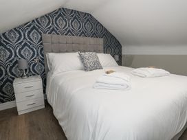 A bedroom with a bed and bedside table at Vista Mare 3 Weymouth
