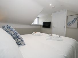 A bedroom with bed and wall-mounted TV at Vista Mare 3 in Weymouth