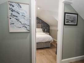 A bedroom with a bed and wall art at Vista Mare 3 Weymouth