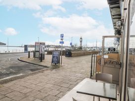 A street view with a clock tower and signage at Vista Mare 3 Weymouth