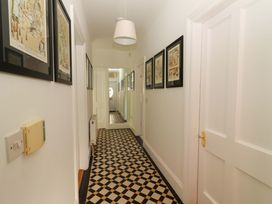 A hallway with framed pictures and patterned floor tiles at Rosemont in Adare