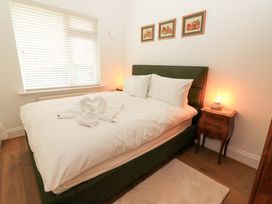 A bedroom with a green bed and nightstand at Rosemont in Adare