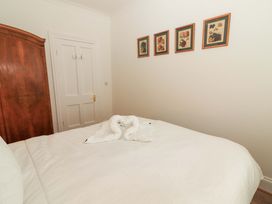 A bedroom with a bed and wardrobe at Rosemont in Adare