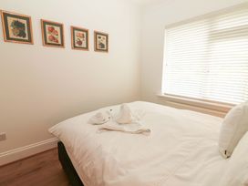 A bedroom with a bed and wall art at Rosemont in Adare