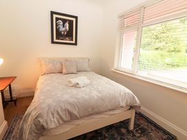 A bedroom with a bed and a painting at Rosemont in Adare