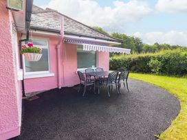 An outdoor seating area with a table and chairs at Rosemont in Adare