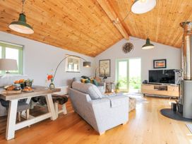 A living room with a sofa and dining table at Smugglers Bodmin Moor, St Breward near St Tudy