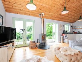 A living room with a stove and television at Smugglers Bodmin Moor, St Breward near St Tudy