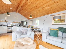 A living room with a couch and a dining area at Smugglers Bodmin Moor, St Breward near St Tudy