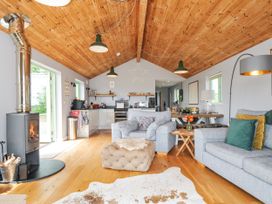 A living room with a sofa and a fireplace at Smugglers Bodmin Moor, St Breward near St Tudy
