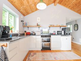 A kitchen with appliances and shelves at Smugglers Bodmin Moor St Breward near St Tudy