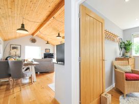 A living room with a dining area and a door at Smugglers, Bodmin Moor, St Breward near St Tudy