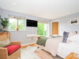 A bedroom with a bed and TV at Smugglers Bodmin Moor, St Breward near St Tudy