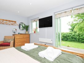 A bedroom with a bed and TV at Smugglers Bodmin Moor, St Breward near St Tudy