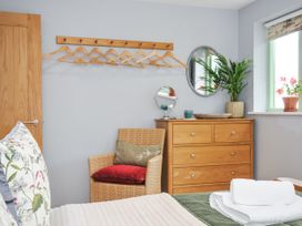 A bedroom with a hanger rack and dresser at Smugglers Bodmin Moor, St Breward near St Tudy