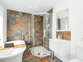 A bathroom with a bathtub and shower at Smugglers, Bodmin Moor, St Breward near St Tudy