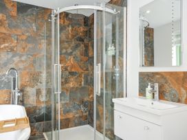 A bathroom with a shower and bathtub at Smugglers in Bodmin Moor, St Breward near St Tudy