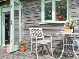 An outdoor patio with a table and chair at Smugglers Bodmin Moor, St Breward near St Tudy