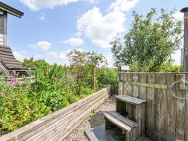 An outdoor shower with wooden steps in a garden at Smugglers, Bodmin Moor, St Breward near St Tudy