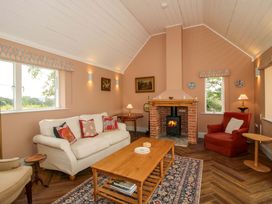 A living room with a sofa and fireplace at Hoddell Pitch Cottage Kinnerton near New Radnor