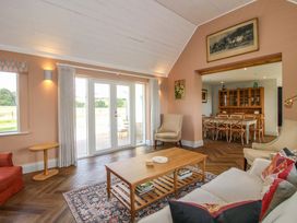 A living room with a sofa and coffee table at Hoddell Pitch Cottage in Kinnerton near New Radnor