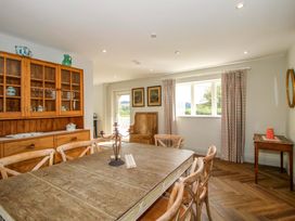 A dining room with a wooden table and chairs at Hoddell Pitch Cottage Kinnerton near New Radnor