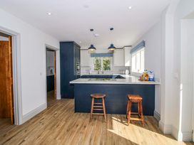 A kitchen with a countertop and stools at Hoddell Pitch Cottage Kinnerton near New Radnor